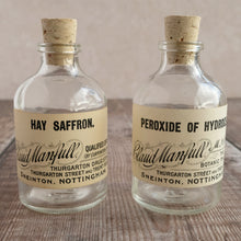 Load image into Gallery viewer, Small apothecary bottle featuring an original vintage label with a beautiful script design (Claud Manfull options)