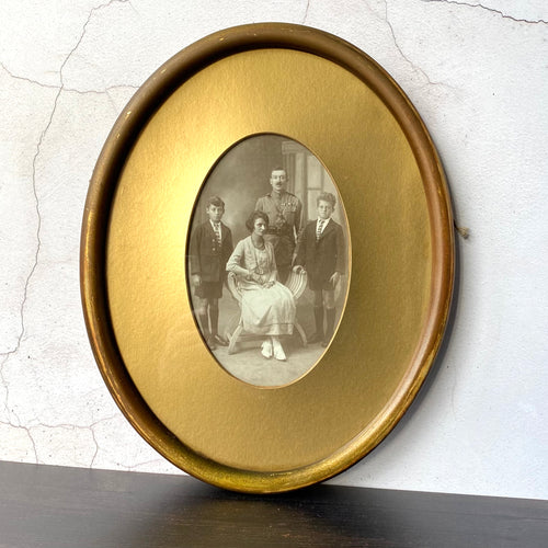 Oval framed vintage sepia family portrait.