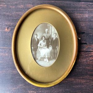 Oval framed vintage sepia family portrait.
