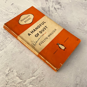 A Handful of Dust by Evelyn Waugh.  Penguin Books paperback 822.  1955.