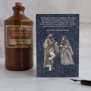 Jane Eyre quotation card beside stone ink bottle.