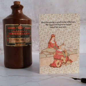 Stone writing fluid bottle with The Queen of Hearts card.